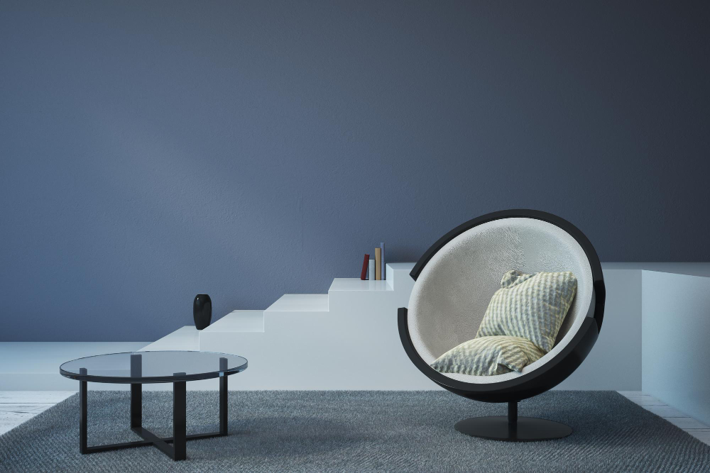 A chair and table set against blue walls in a cozy room, creating a serene and inviting atmosphere.